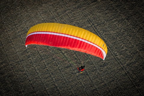 Paraglider over ploughed field
