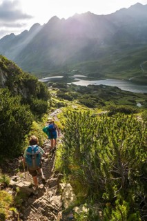 Two hikers on a trail in the morning