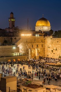 Believers at the Wailing Wall at dusk