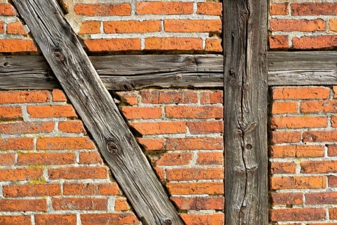 Brick wall with half-timbered beams