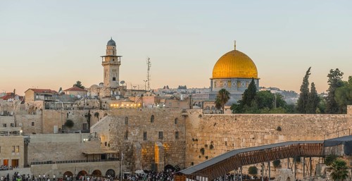 Believers at the Wailing Wall at dusk