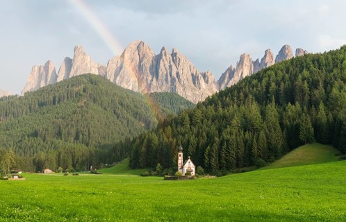 Rainbow in front of the church St. Johann in Ranui