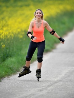 Inline skating alongside blooming rape field