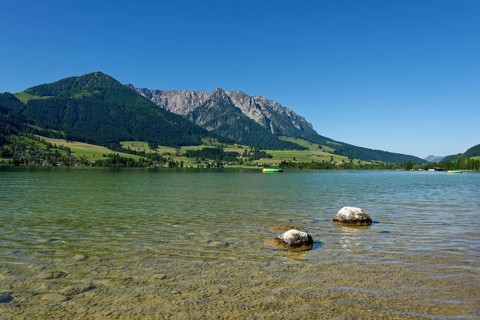 Lake Walchsee in front of mountain range Zahmer Kaiser