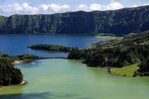 View from Miradouro da Vista do Rei into the volcanic crater Caldera Sete Cidades with the crater lakes Lagoa Verde and Lago Azul