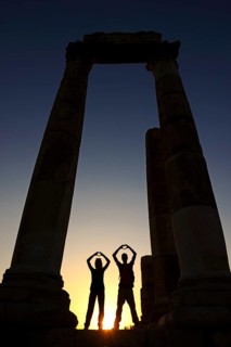 Couple forms a heart in sunset at the Temple of Hercules at the Citadel