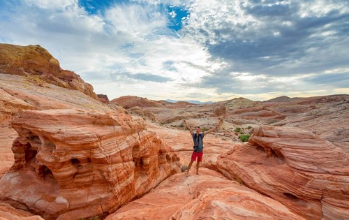 Young man posing with outstretched arms