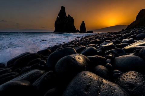 Rock formation Ribeira de Janela at sunrise with black stones at the beach