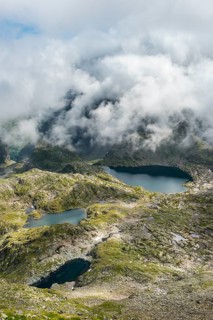 Clouds passing over a ridge with mountain lakes