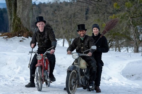 Chimney sweepers in winter on old mopeds