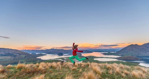 Hiker jumping in the air