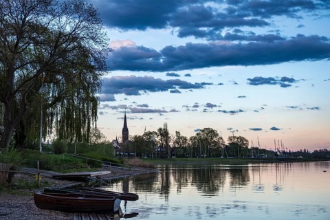 Rowboats by the lake at sunset