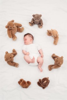 Baby sleeping with teddy bear Austria