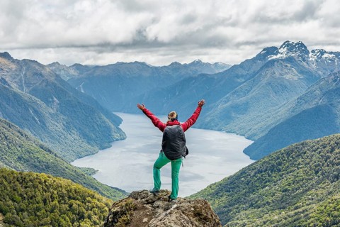 Female hiker is looking at the South Fiord of Lake Te Anau