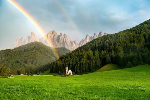 Rainbow in front of the church St. Johann in Ranui