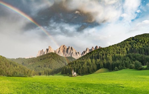 Rainbow in front of the church St. Johann in Ranui