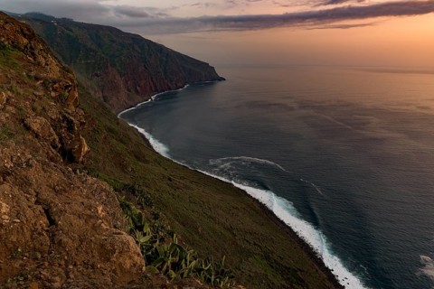 High bank with sea at sunset