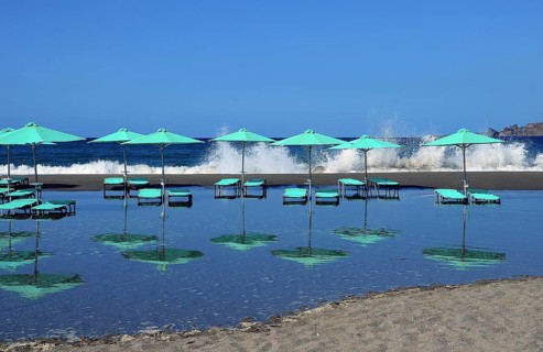 Green umbrellas and sun loungers
