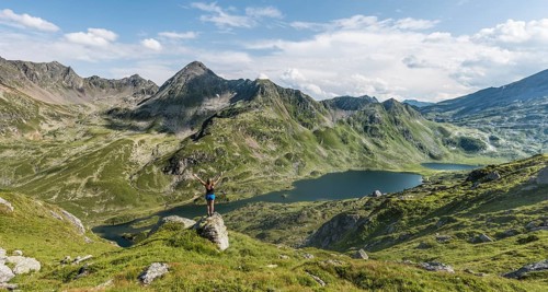 Hiker stretching arms in the air