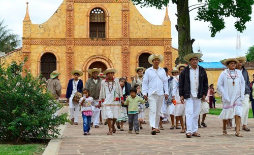 Locals dressed in festive costumes on the day of tradition in front of the Jesuit mission