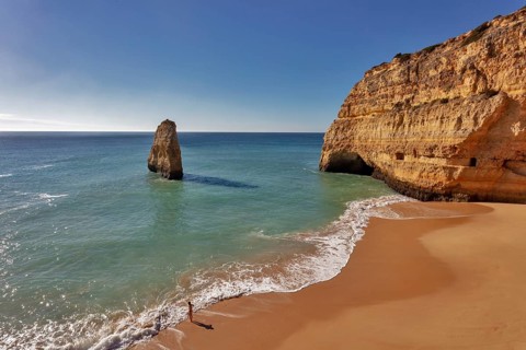 Rock at the sandy beach Praia do Carvalho