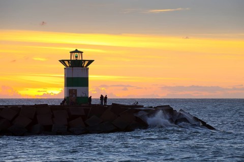 Small lighthouse at harbor entrance