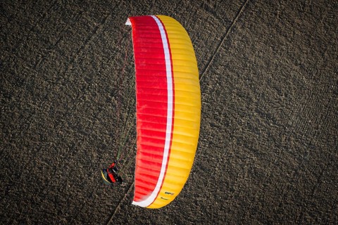 Paraglider over ploughed field