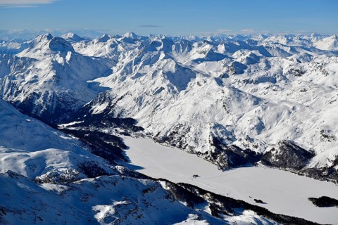 Snow-covered Lake Sils with snow-covered mountains