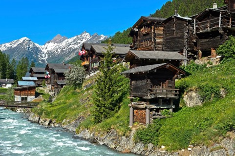 Listed townscape with Swiss chalet houses in front of Valais Alps