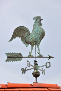 Weathercock with cardinal points on roof