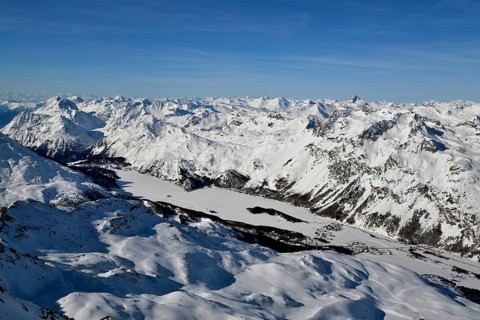 Snow-covered Lake Sils with snow-covered mountains