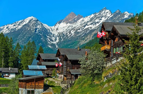 Listed townscape with Swiss chalet houses in front of Valais Alps