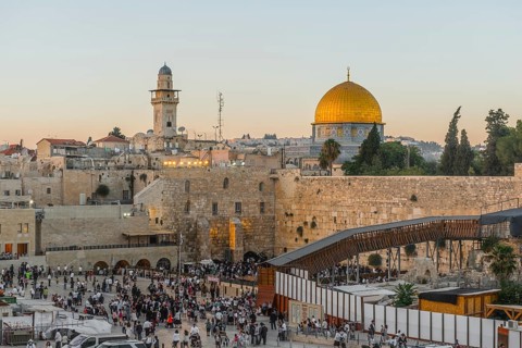 Believers at the Wailing Wall at dusk