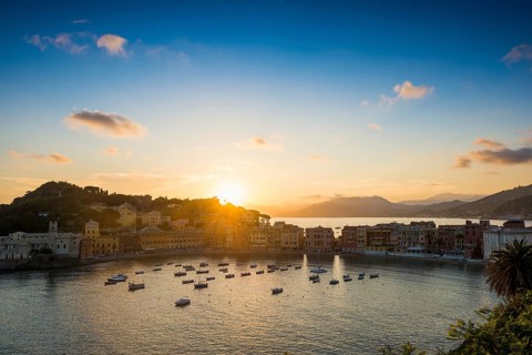 View of the village with harbour in the bay Baia del Silenzio at sunset