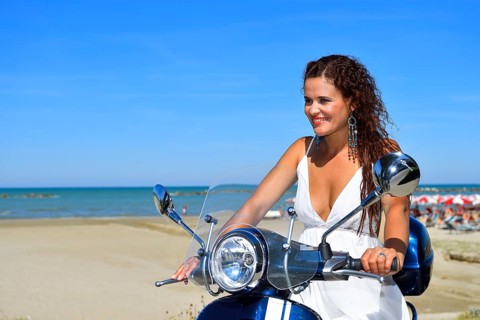 Woman on Vespa scooter