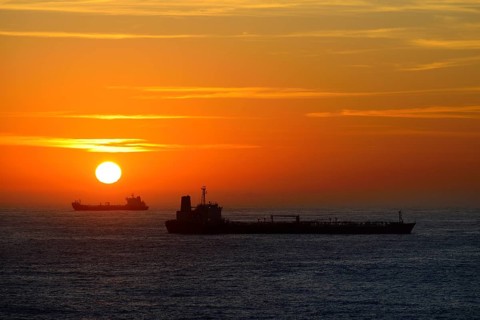 Cargo ships lying on roadstead at sunrise
