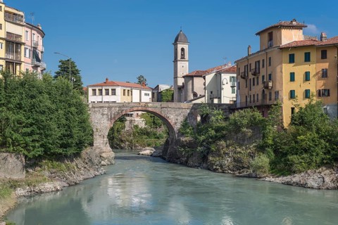 Old Roman bridge Ponte Vecchio over the river Dora Baltea