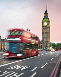 Red double-decker bus on the Westminster Bridge