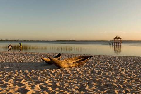 Dugout boat lying on sandy beach