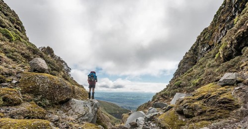 Hiker stands on slope