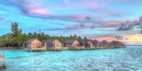 Wooden huts on stilts in lagoon
