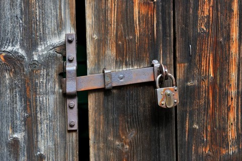Rusty door handle with door lock on old wooden door