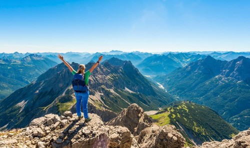 Hiker with views of mountains and Alps