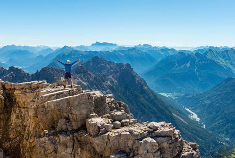 Hiker stretching arms in the air
