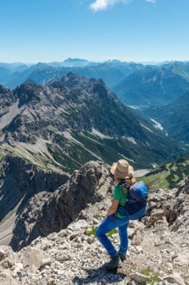 Hiker overlooks mountains and Alps