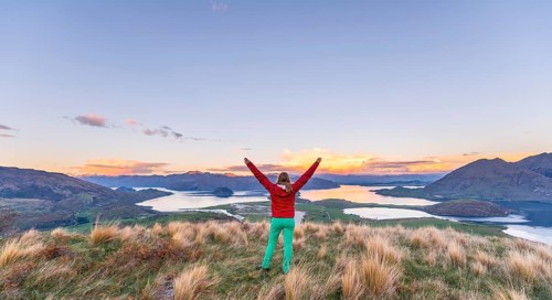 Hiker with arms spread out in the air
