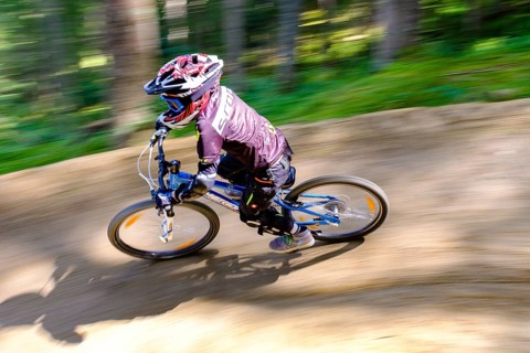 Child 9 years old rides on a mountain bike downhill