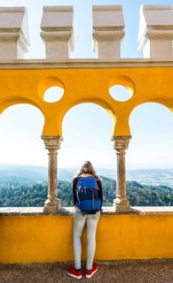Young woman looking across landscape from Pena Palace