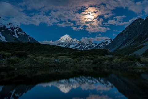 Mount Cook is reflected at moonlight in the pond