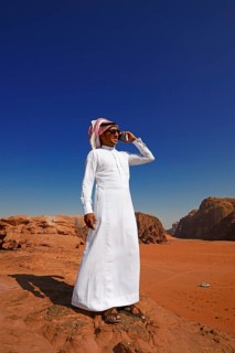 Bedouin uses his smartphone at Rock Arch